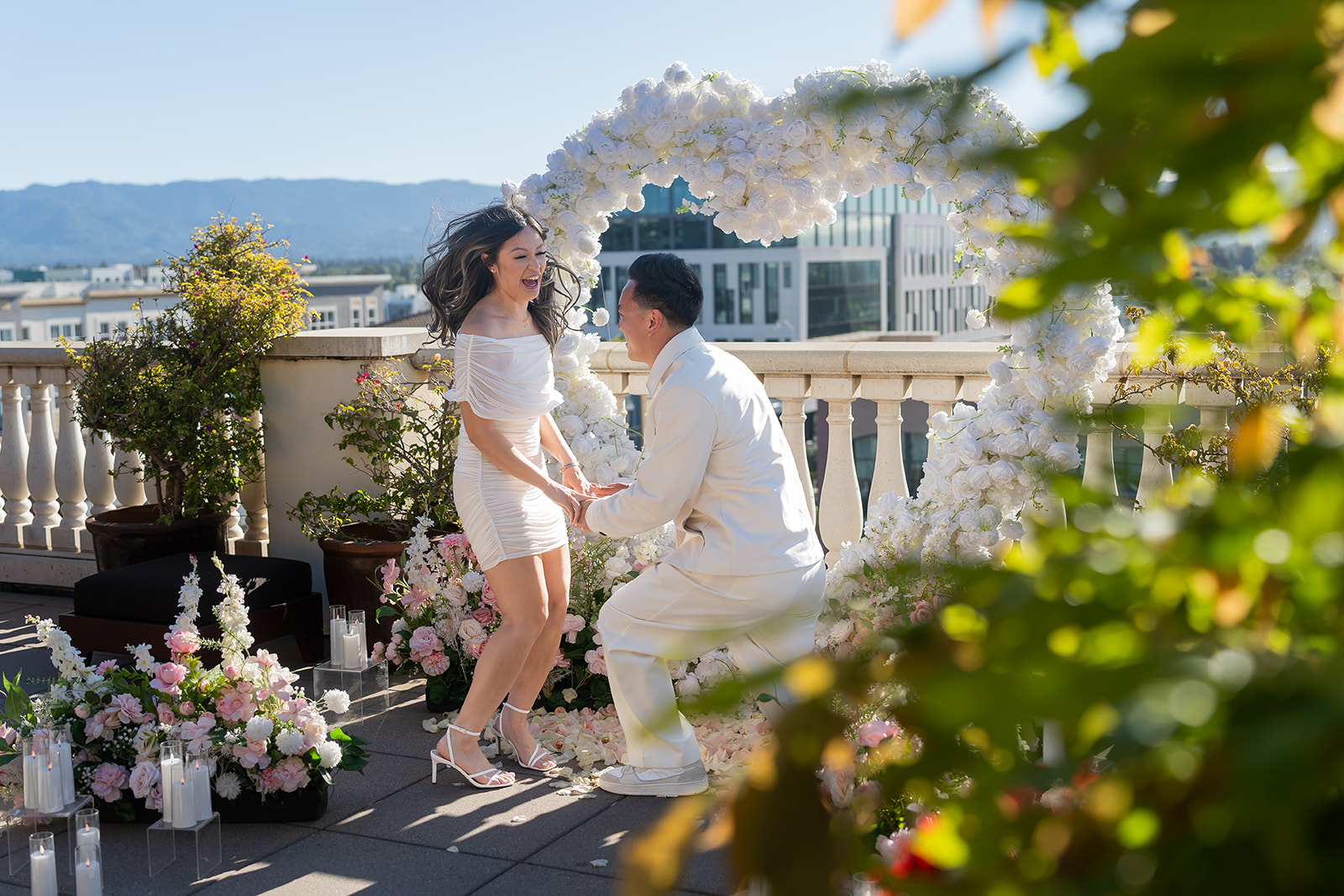 Couple celebrating a Cielo Rooftop proposal with friends at Santana Row
