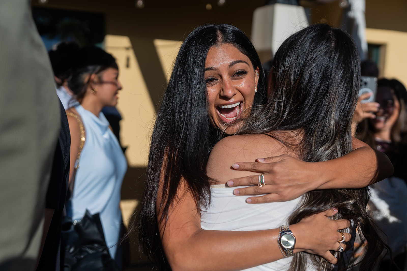 Friends embracing the newly engaged couple at Cielo Rooftop