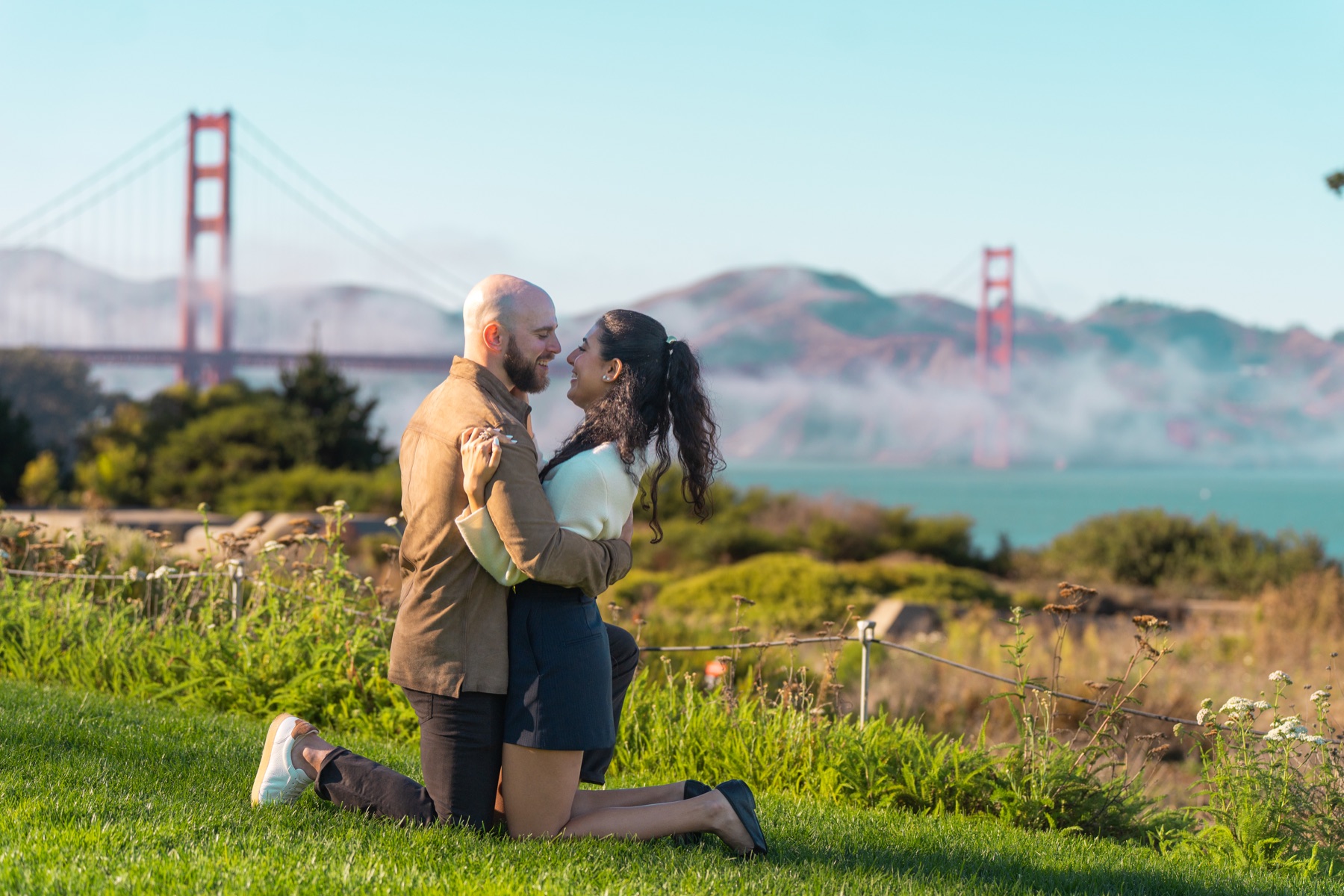 Alex and Abby embracing after their Golden Gate Bridge proposal
