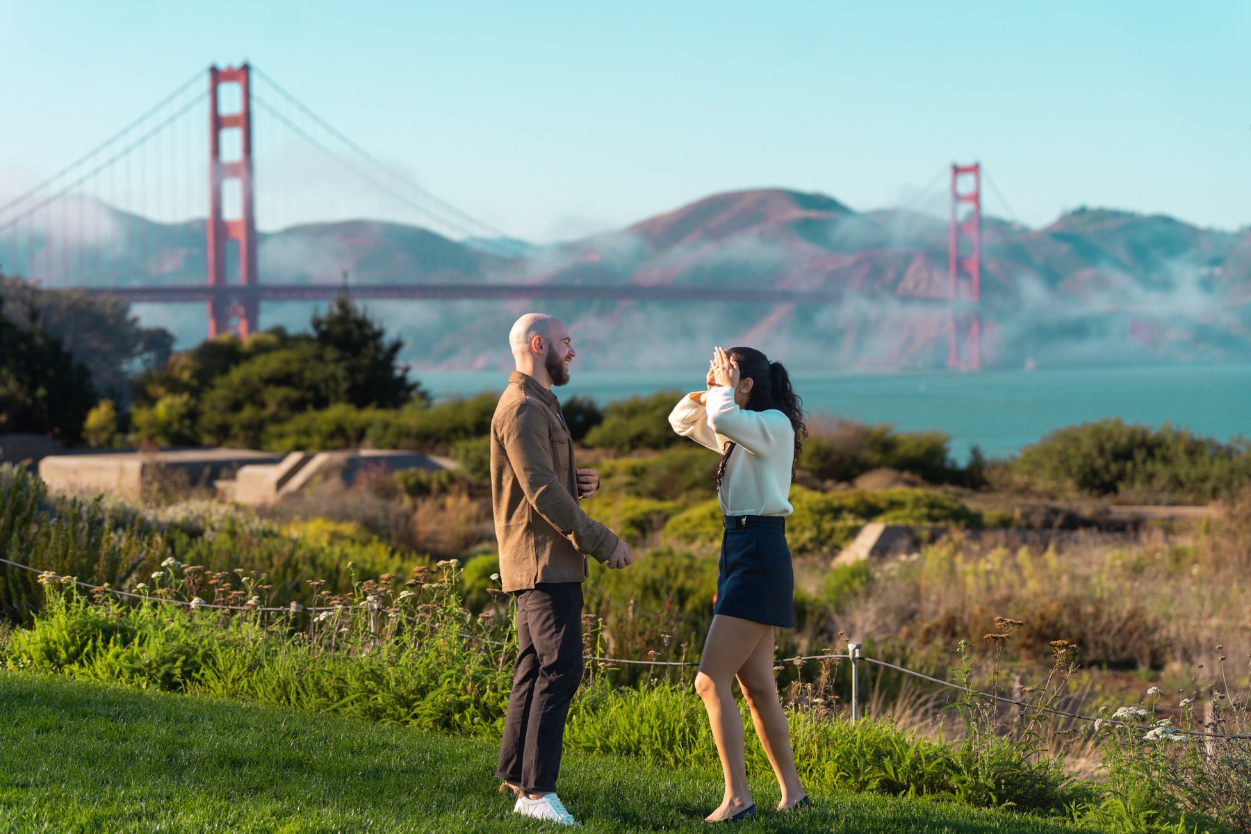 Alex and Abby sharing a natural pause during their Golden Gate Bridge proposal story