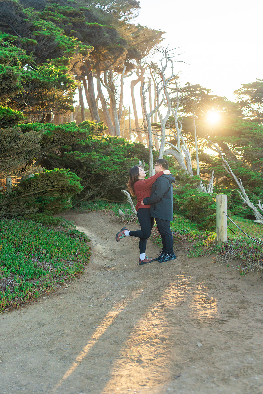 Couple walking together after a surprise proposal at Lands End