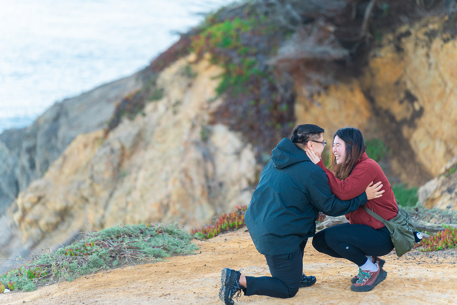 Couple sharing a coastal portrait after their Lands End proposal