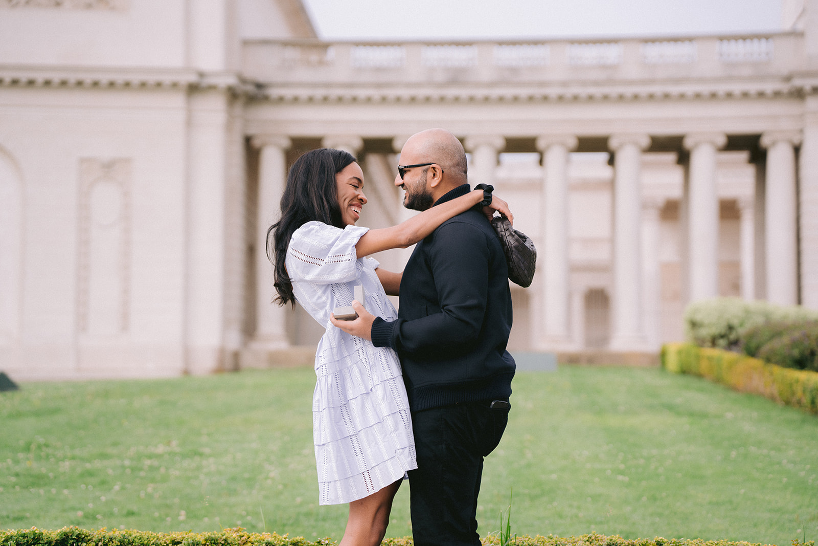 Couple walking together after a proposal at the Legion of Honor
