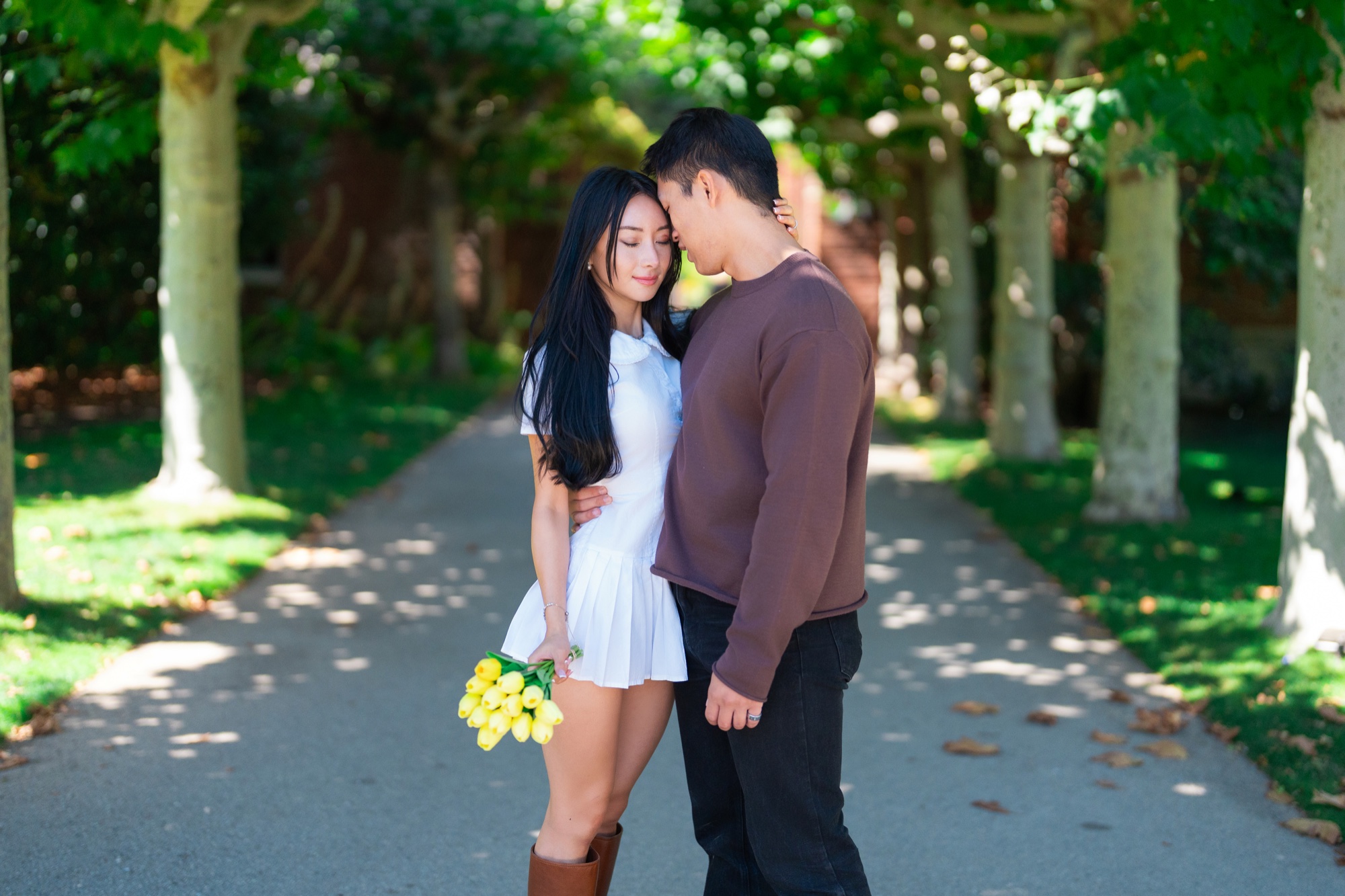 Ernest and Alexandra standing beneath the trees at Filoli with yellow tulips