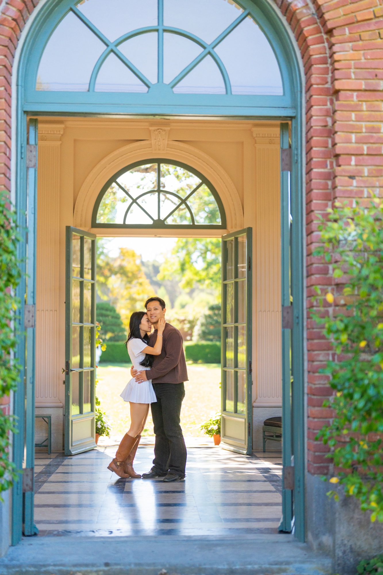 Ernest and Alexandra framed by the arched doorway of Filoli’s historic house